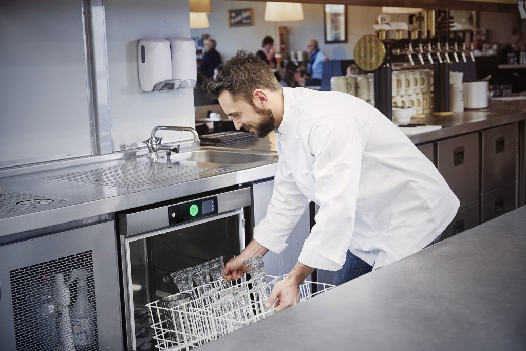 Chef filling dishwasher